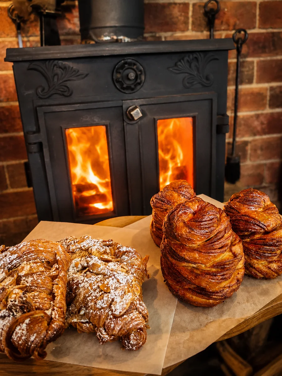 Fresh pastries beside a wood-burning stove